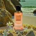 ForKumi tropical vanilla musk perfume bottle on sandy beach with white flowers and rocks