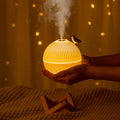 ForKumi ultrasonic humidifier with essential oils emitting mist with warm glowing light held in hands