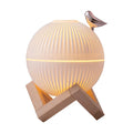 ForKumi ultrasonic humidifier with essential oils featuring round white ribbed design and wooden stand with bird accent