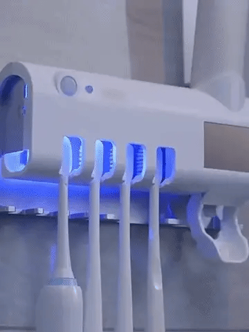 ForKumi UV toothbrush sanitizer and holder mounted on wall with five toothbrush slots and blue UV light