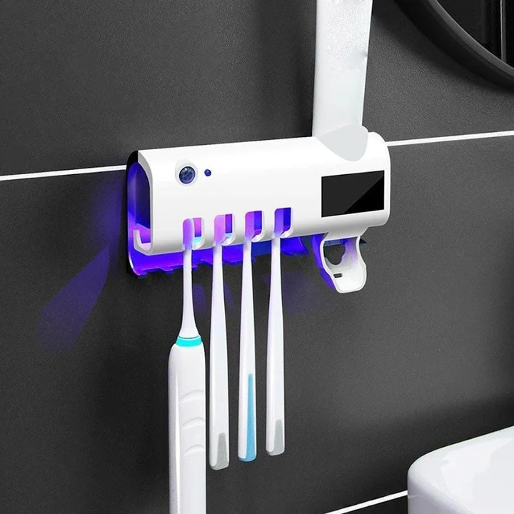 ForKumi UV toothbrush sanitizer and holder mounted on wall with five toothbrush slots and blue UV light