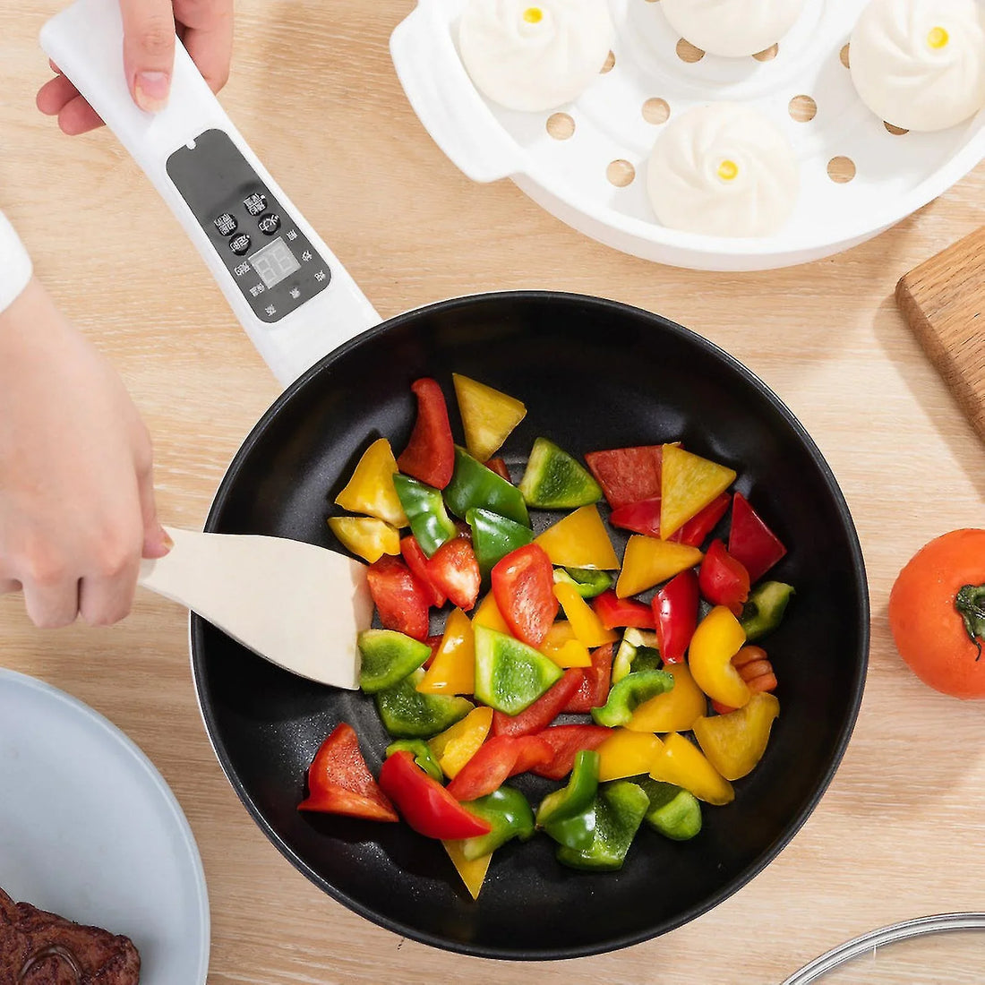 ForKumi 6-in-1 smart cooker white electric pot with vegetables being stirred on wooden table