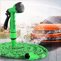 ForKumi 60m expandable garden hose with green spray nozzle washing an orange car outdoors