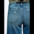 Close-up back view of Avis mid-low stretch jeans for women in distressed blue denim fabric