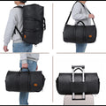 Black PU leather duffel bag carried as backpack, shoulder bag, hand bag, and on a suitcase