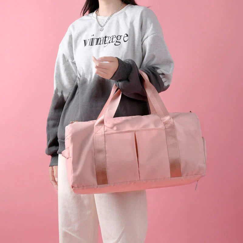 ForKumi pink waterproof gym duffel bag held by person wearing gray and black sweatshirt