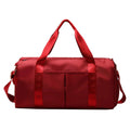 ForKumi red waterproof gym duffel bag with multiple pockets and sturdy handles
