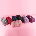 ForKumi waterproof gym duffel bag collection in multiple colors lined up on pink background